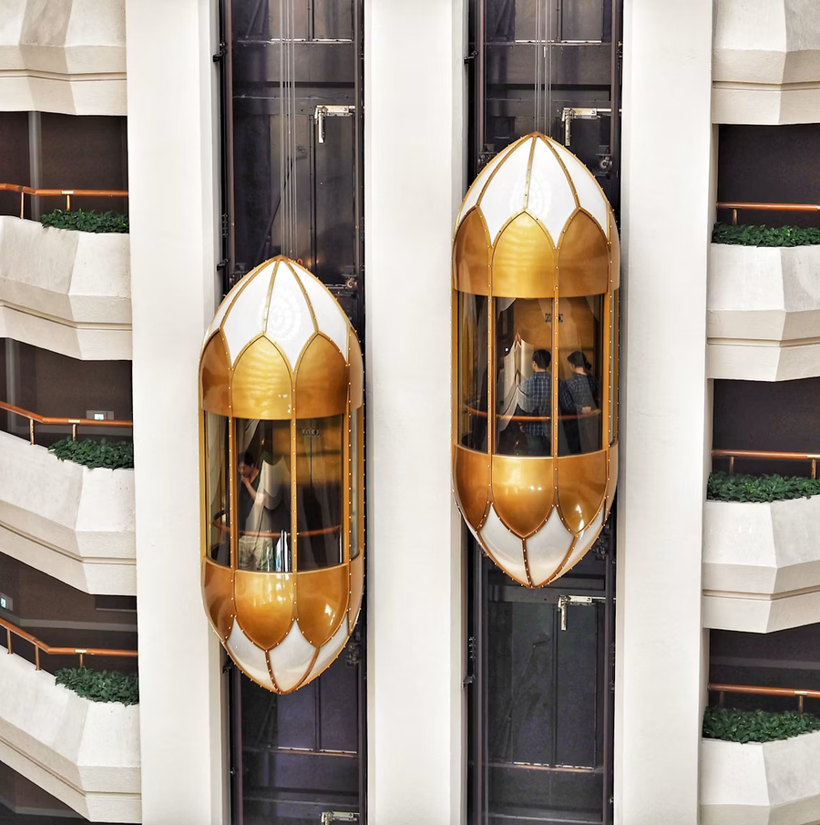 Screenshot 2026-09-14 at 11-22-04 Two gold capsule elevator - Free Photo on Unsplash