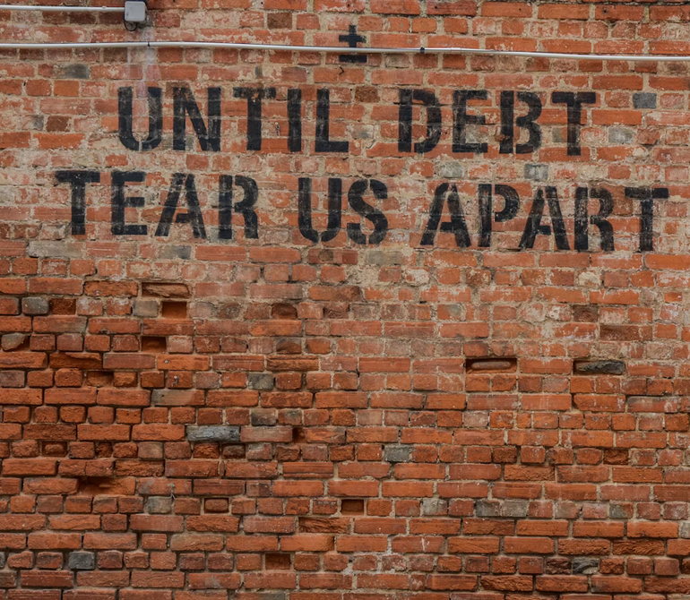 Screenshot 2026-09-20 at 17-55-07 Until debt tear us apart printed red brick wall at daytime - Free Photo on Unsplash debt