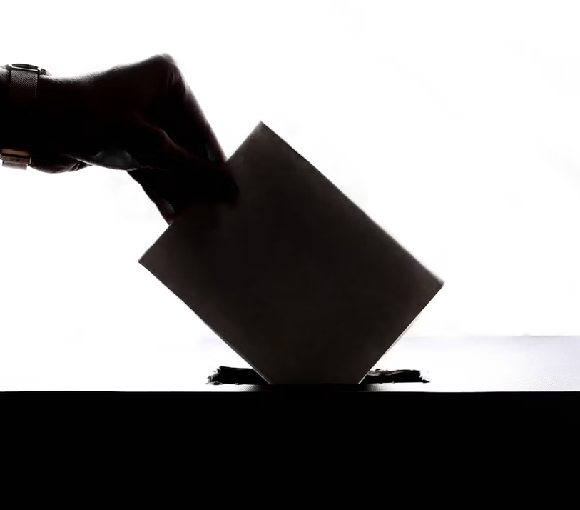 Screenshot 2026-09-24 at 10-30-42 A person is casting a vote into a box - Free Photo on Unsplash
